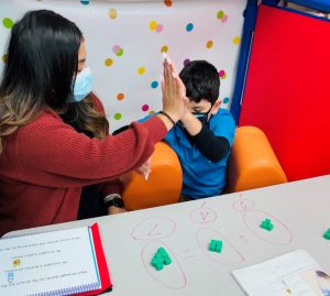 Vivian Gaona and student share a high five after completing a lesson | National Special Education Day | IDEA Public Schools