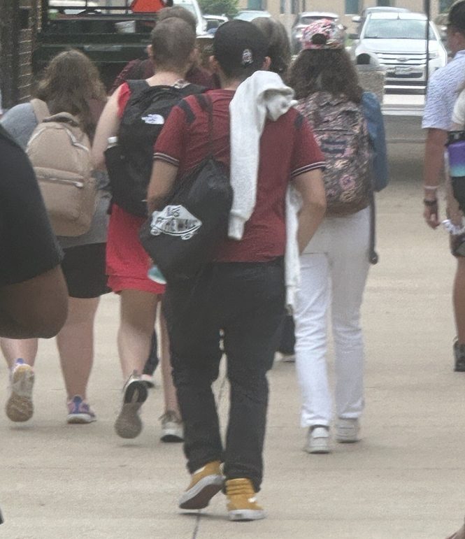 Student walking amongst college peers